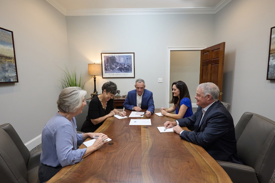 Greg Paschal, Katy Hartnett, Dean Blissit and the leadership team of Palmetto Financial Advisors at a meeting in their offices in Aiken, SC.